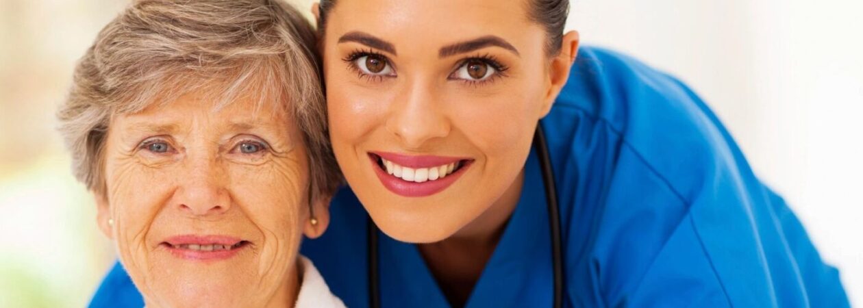 A woman in blue shirt smiling for the camera.