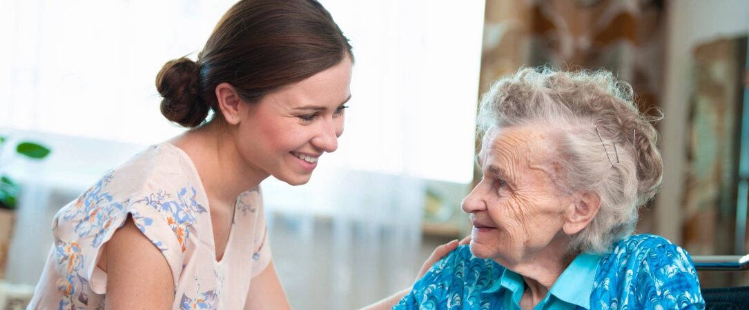 A woman and an old lady smiling for the camera.